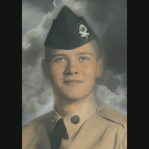A portrait photo of Douglas B. Tuthill in his service uniform holding his head high and with a proud smile