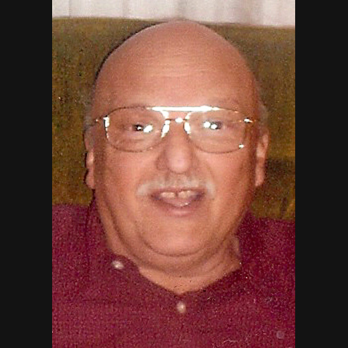 A close-up photo of Robert W. DeGidio smiling