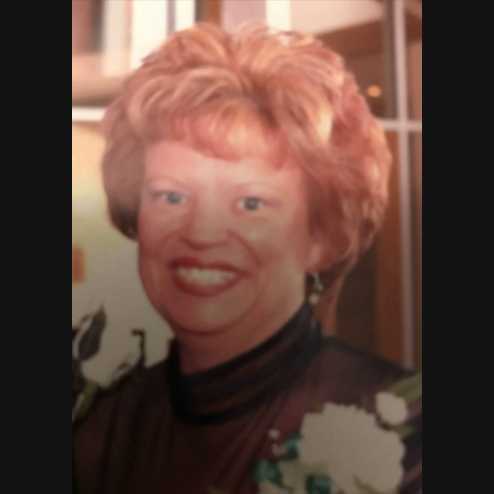 A close-up photo of Linda L. Mekus smiling happily at the camera