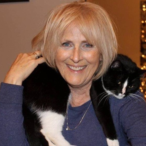 Margaret "Maggie" Hadden smiling and posing for a photo with her cat