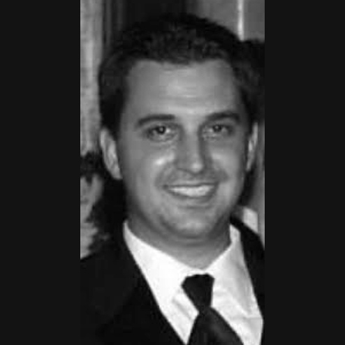 A black and white portrait photo of Darren D. OBrien smiling