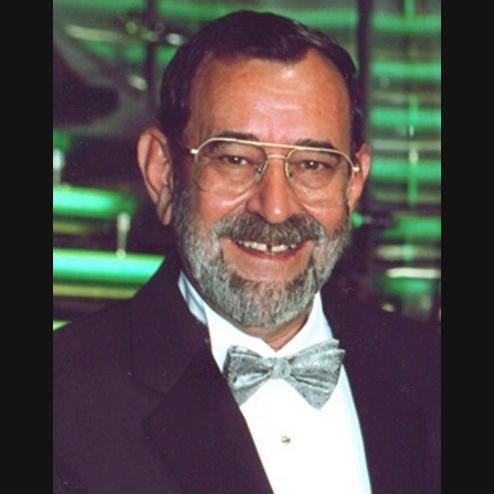 A portrait photo of Luis "Lou" Moreiras smiling and dressed for a formal event