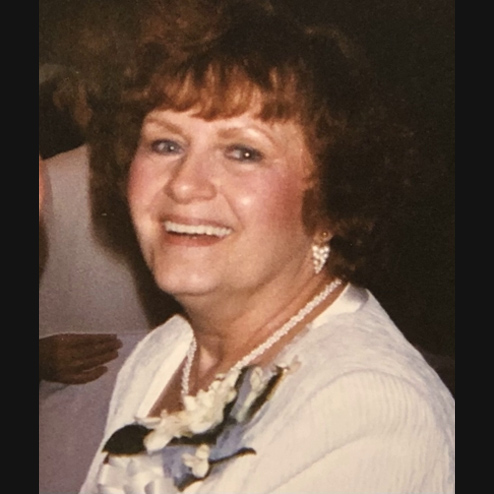 A close-up photo of Janet Carol Siegel smiling and enjoying a formal event