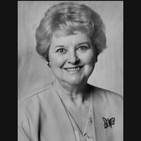 A black and white portrait photo of Nancy North Foreman formerly Hunter smiling very contently into the camera