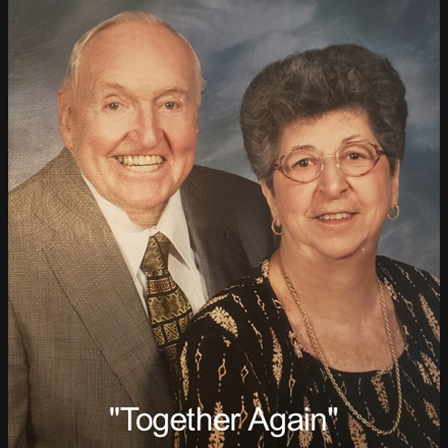 Olga Cowper and lifelong partner posing together with the words "Together Again" at the bottom of the photo