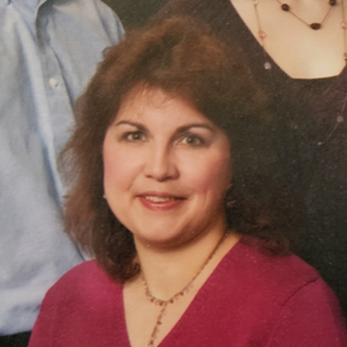 A close-up photo of Mary Elizabeth "Maribeth" Doran Curry smiling and surrounded by her family