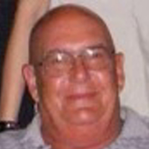 A close-up photo of Norman A. Galon smiling for the camera
