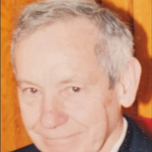 A close-up photo of William Lloyd Scholes smiling into the camera