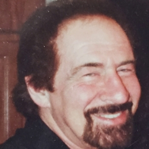 A close-up of Danny Kocher laughing and smiling
