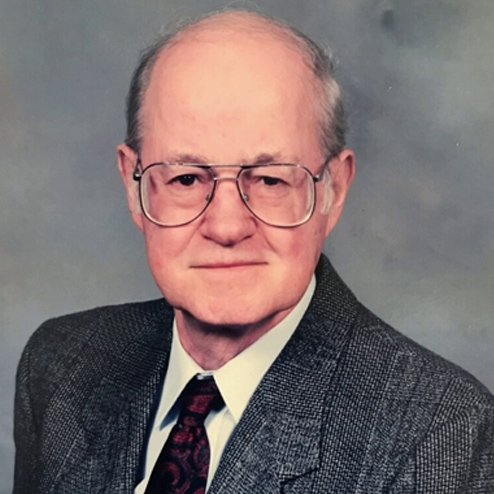A professional portrait photo of Phillip Lunchar dressed up in a suit and tie