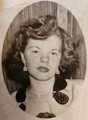 A black and white portrait photo of Mary Lou Gomez formerly Bliss looking at the camera