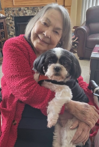 Kathleen "Kitty" Gordon posing with a cute dog in a home