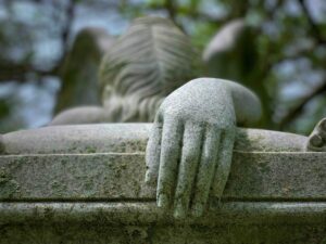 A grieving angel resting its hand on a grave